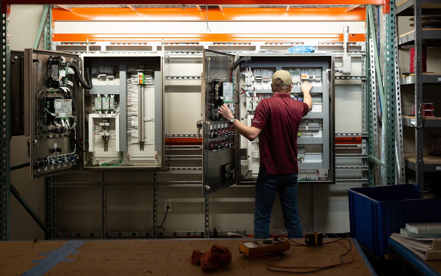 Drake Controls technician wiring open control cabinets in the shop